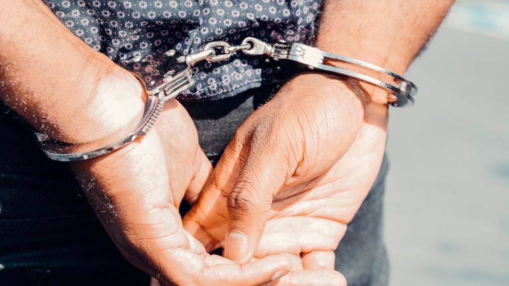 close-up of hands in handcuffs